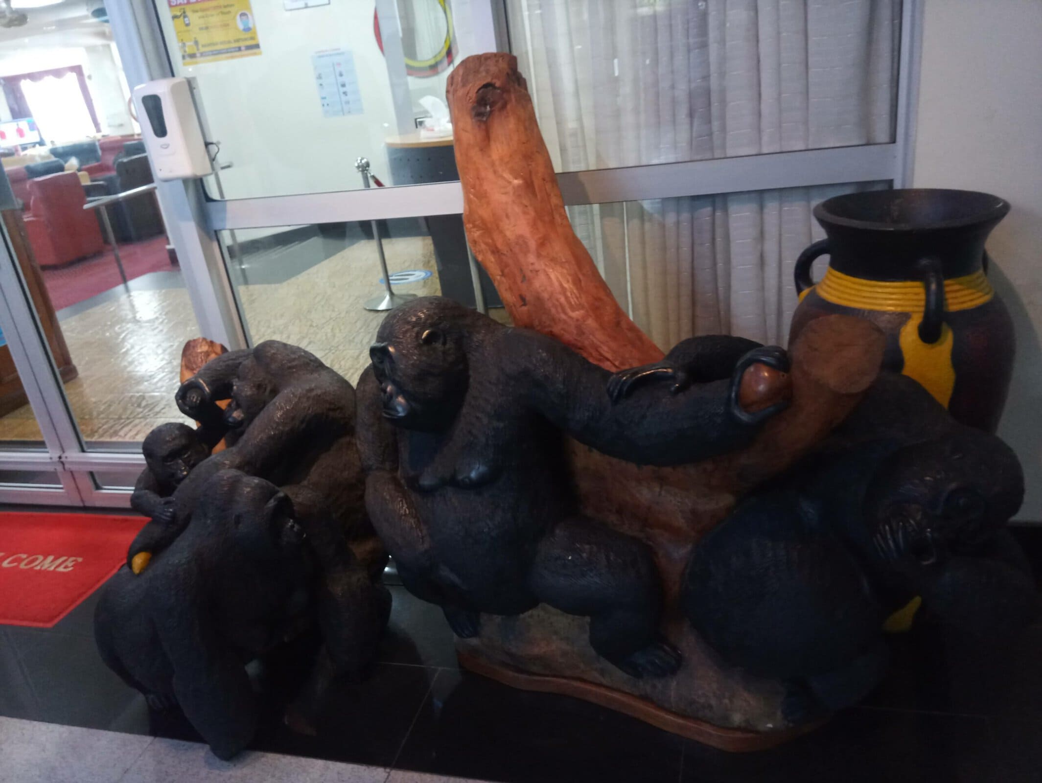 Wooden gorilla sculpture at Psalms of Sarah, showcasing handcrafted art and cultural decor.