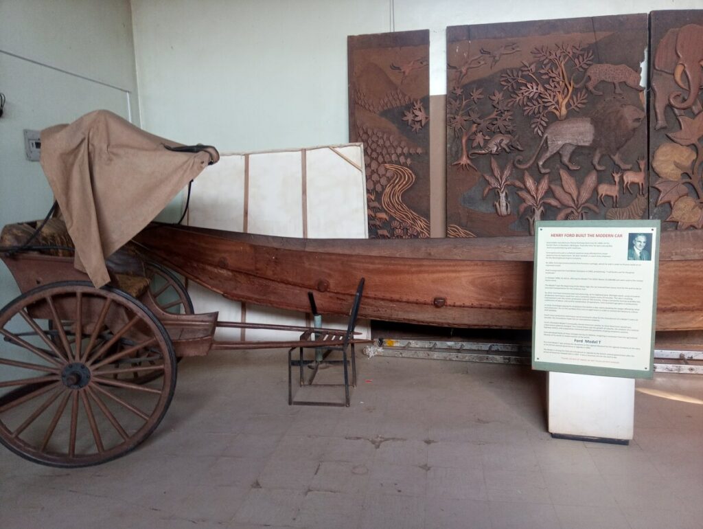 An antique wooden canoe on display at the Uganda Museum, representing historical water transportation methods in Uganda.