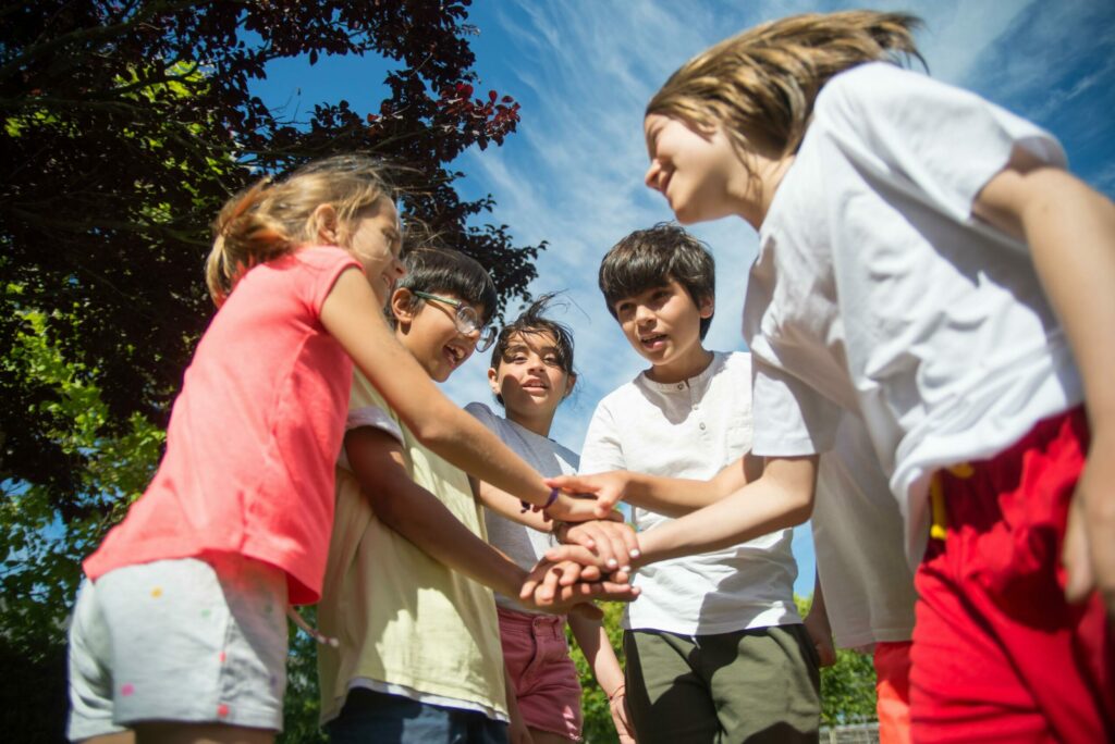 A group of chilfren about to play a game smiling