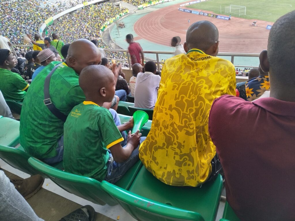 Thousands of enthusiastic fans at Benjamin Mkapa Stadium in Dar es Salaam, Tanzania, during a football match.