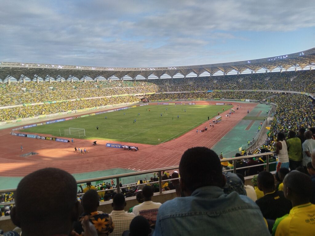 Thousands of passionate Young Africans SC supporters cheering in the stands at Benjamin Mkapa Stadium in Dar es Salaam.