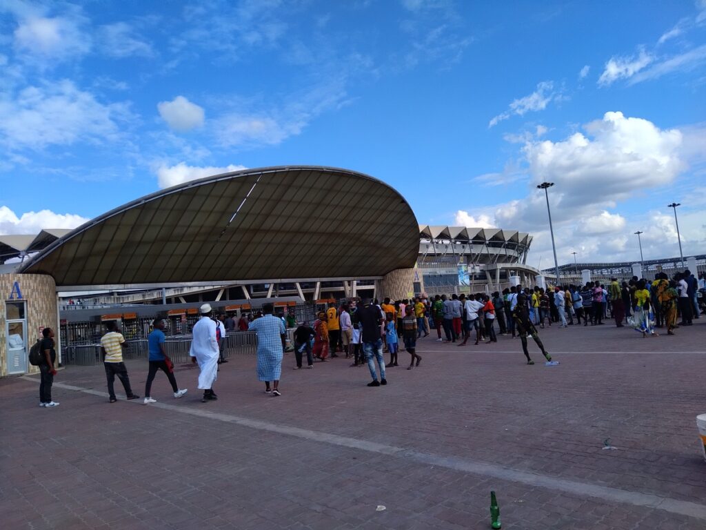 football fans walking in and out of the stadium having things to do in dar es salaam.