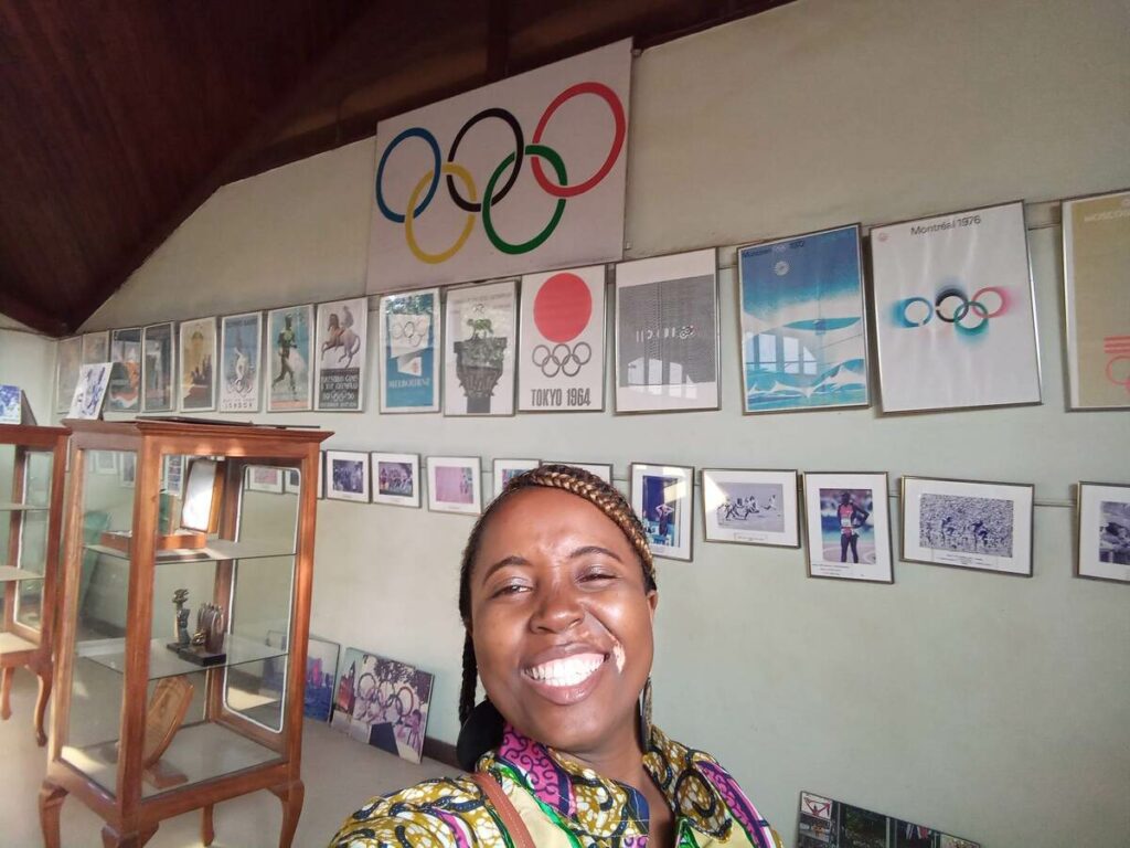 A wall inside the Uganda Museum displaying a collection of photographs and labels documenting Uganda's participation in the Olympic Games.