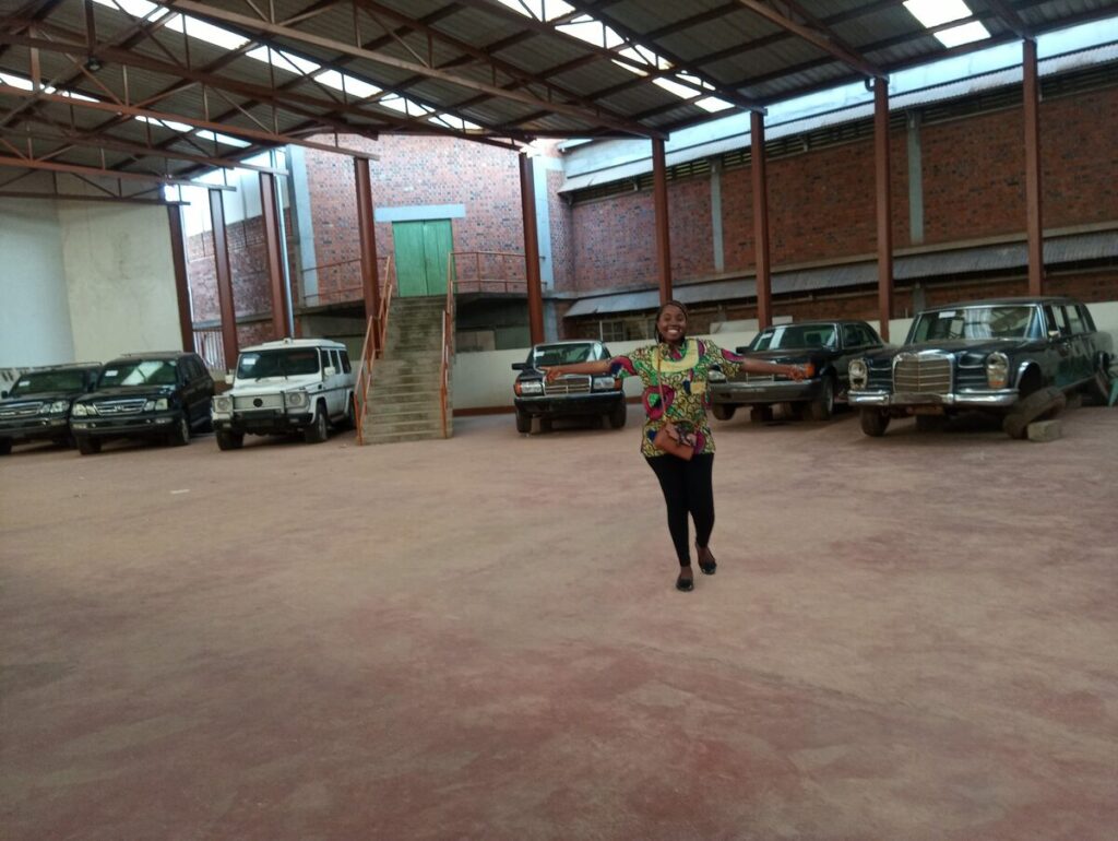 A collection of historical state vehicles, including presidential cars, displayed in the underground parking gallery at the Uganda Museum.