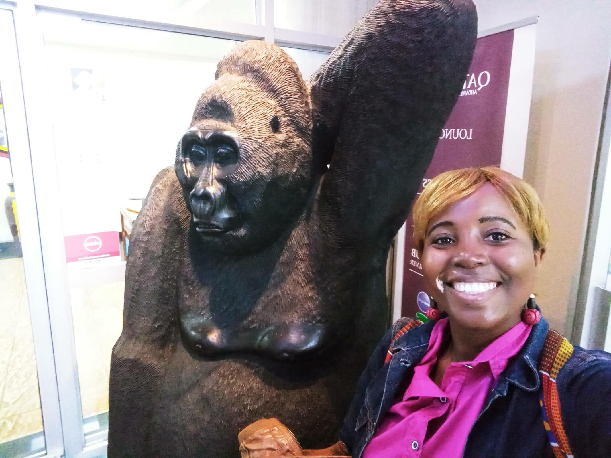 Sarah inside the new departures terminal extension at Entebbe Airport Uganda with the gorilla statute